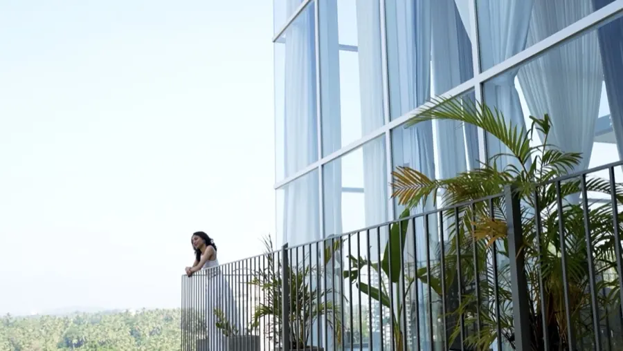 Terrace above the treeline against the glass facade
